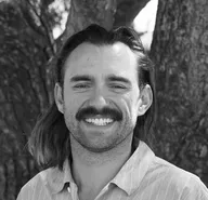 black-and-white headshot of Tyson Maynes